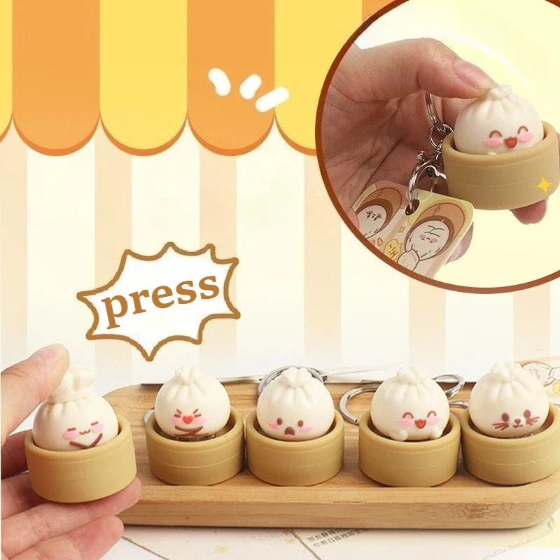 Dumpling fidget clicker keychain with tan container and cute face, metal ring