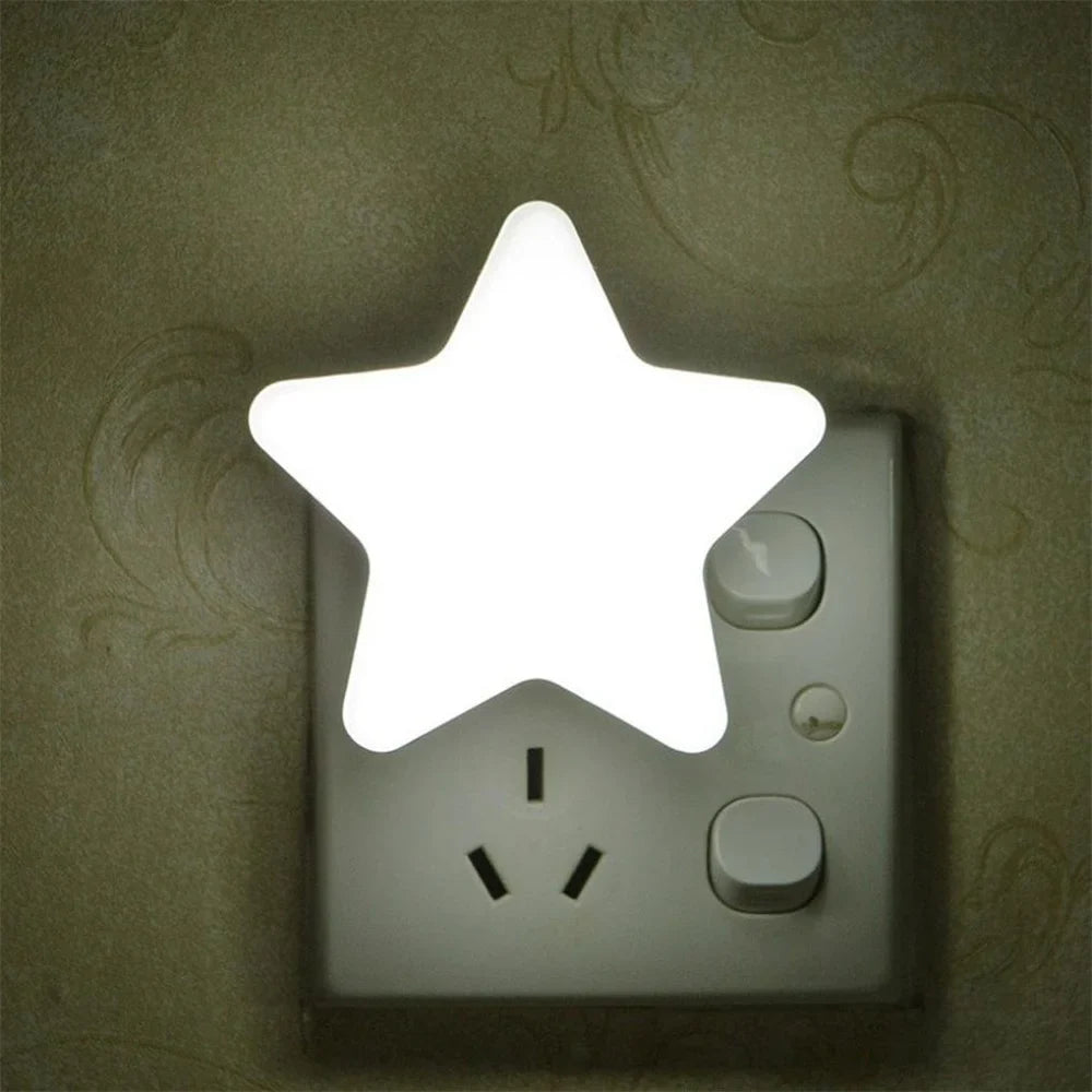 White star LED plug-in night light glowing from a wall outlet.