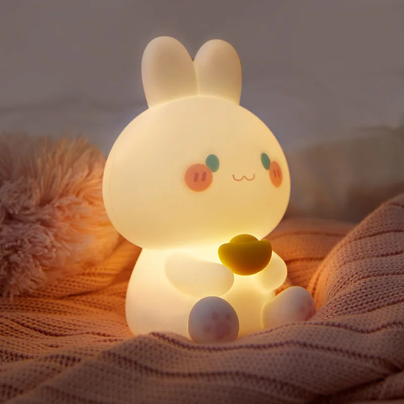 White bunny night light glowing on a soft blanket, yellow heart at the chest