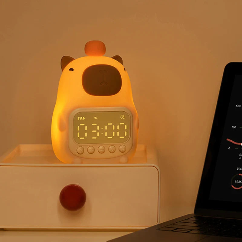 Capybara-shaped night light alarm clock with glowing digital display and buttons