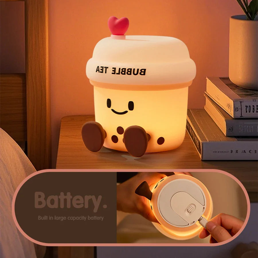 Kawaii bubble tea cup night light glowing with heart lid and a hand showing the battery door.