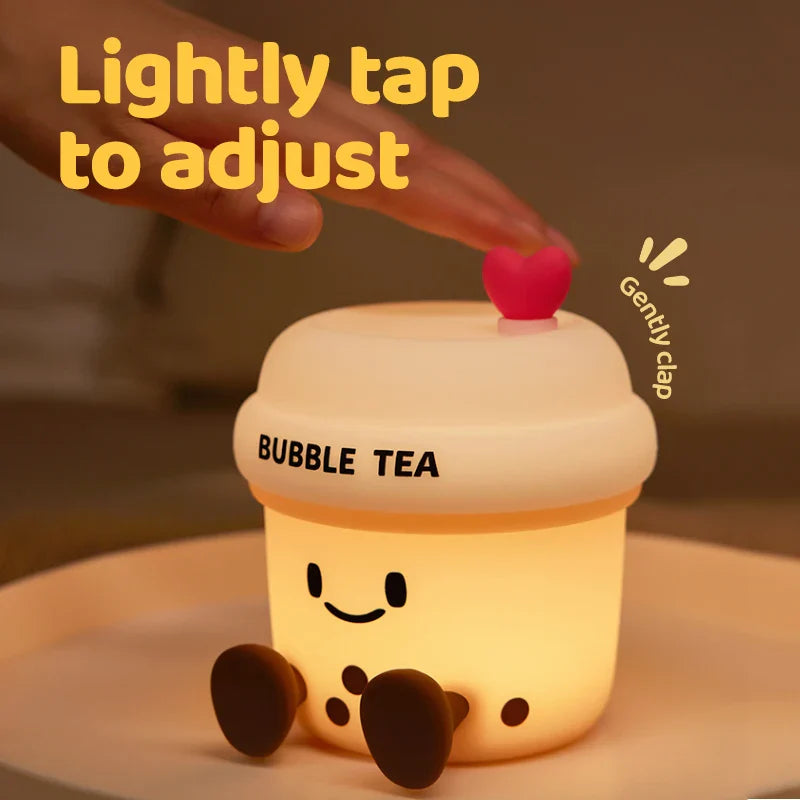 Kawaii bubble tea cup night light with glowing smile, heart lid, and finger tap on top.