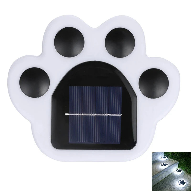 Close-up of white paw-shaped solar light with black solar panel