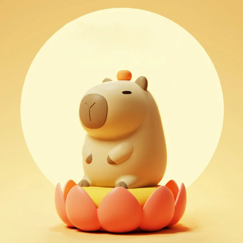 Capybara night light with large glowing halo and small orange knob on head
