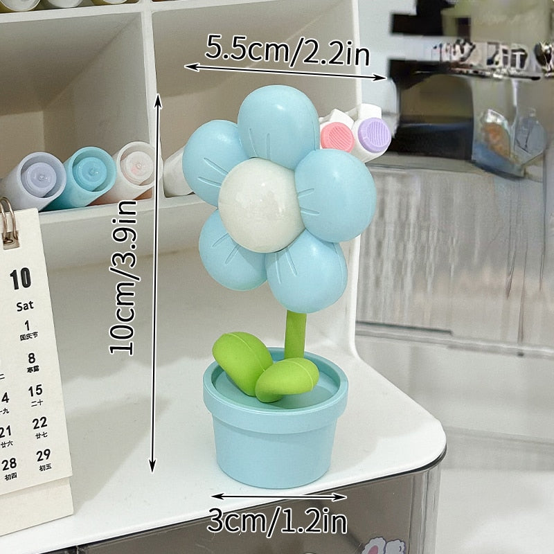 Blue flower night light with glowing center and green leaves in a light blue pot