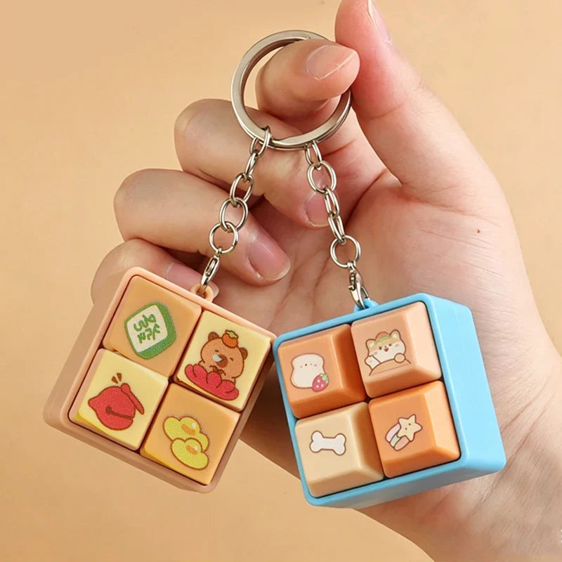 Orange animal fidget clicker keychain cube with bear, heart, and bone icons.