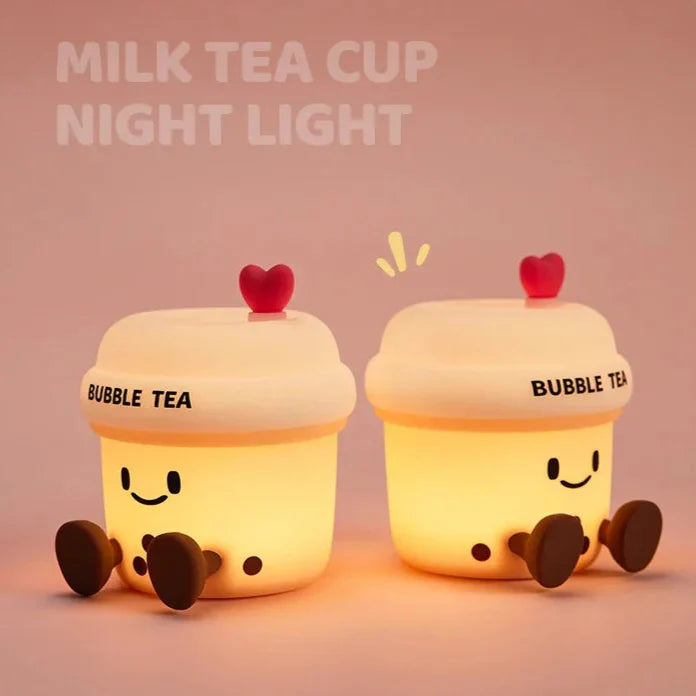 Two glowing kawaii bubble tea cup night lights with heart lids and smiling faces.