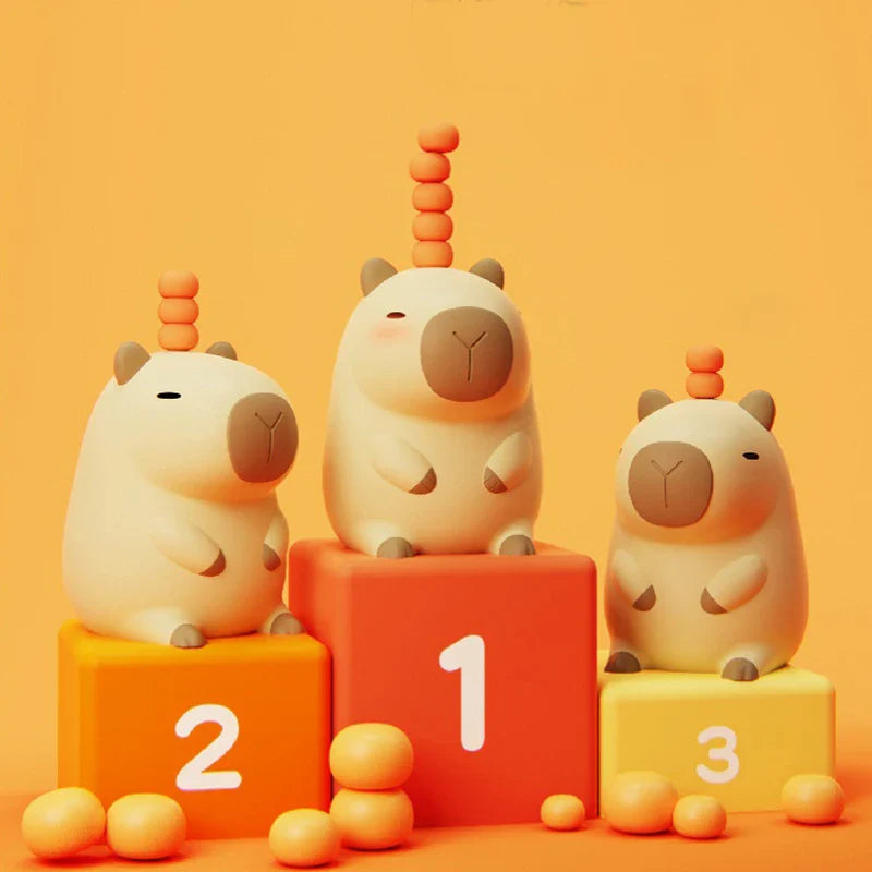 Three capybara night lights with orange knobs on numbered blocks 1, 2, and 3