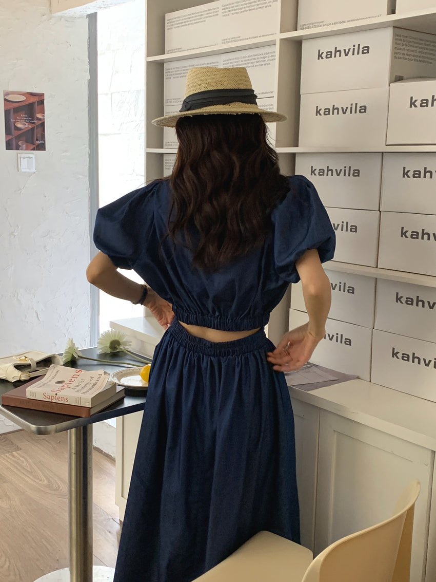 Women’s dark blue denim puff-sleeve crop top with elastic waist and gathered midi skirt, back view