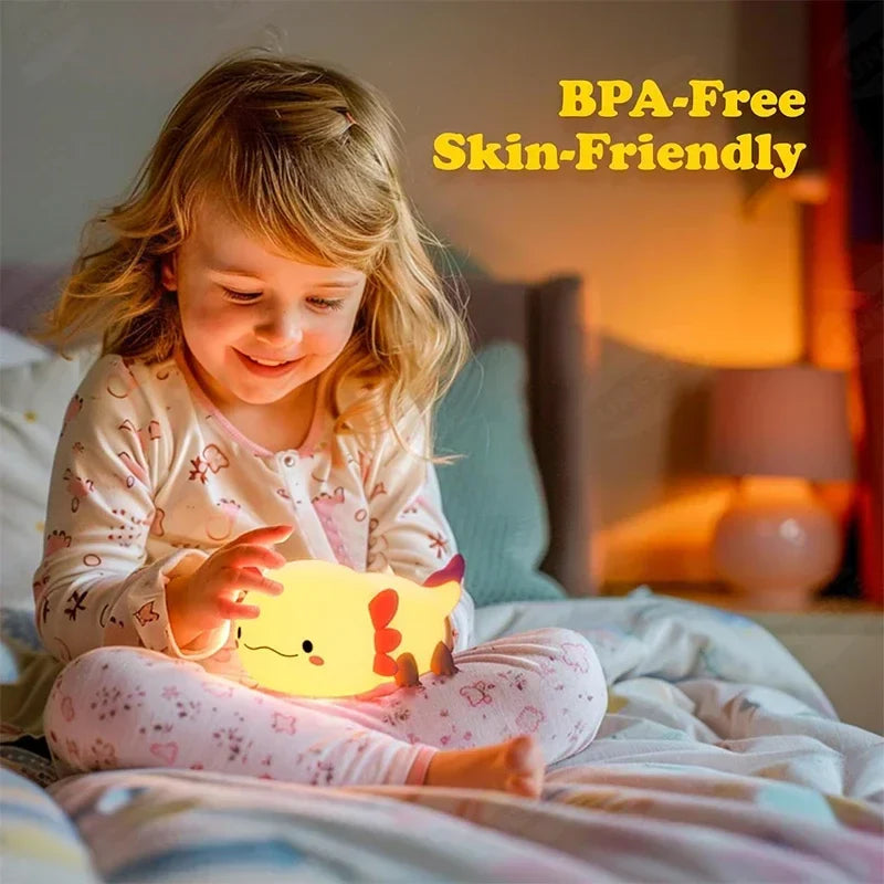 Child holding a glowing cream axolotl night light with pink fins and smiling face