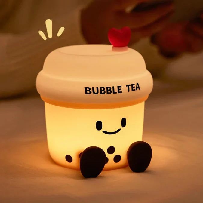 Kawaii bubble tea cup night light glowing with heart topper and smiling face on front.