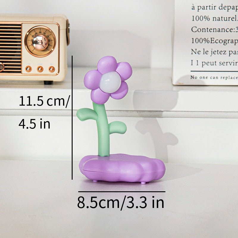 Purple flower night light figurine with glowing base, green stem, and soft flower petals