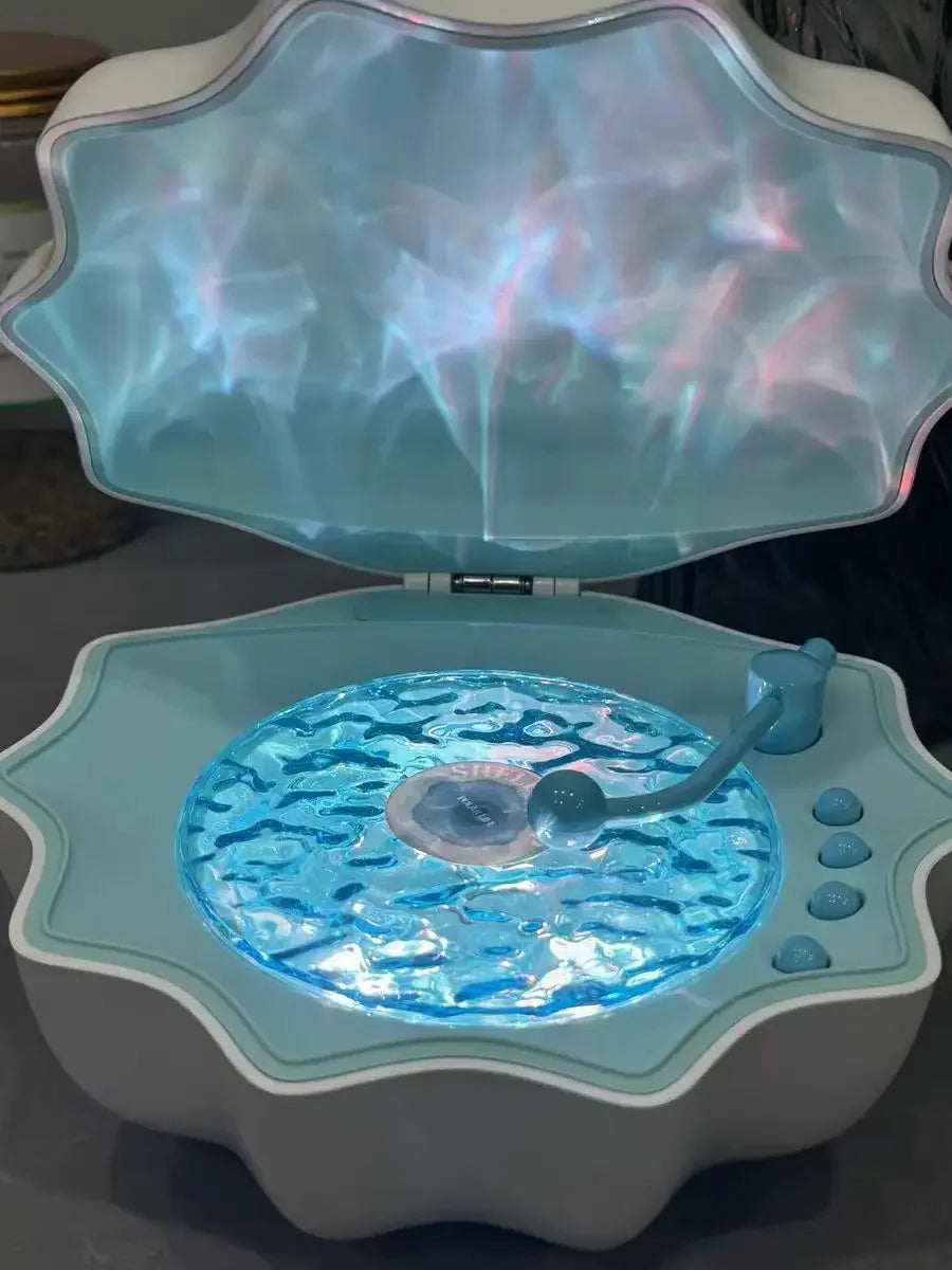 Blue shell Bluetooth speaker night light, lid open with glowing blue light panel