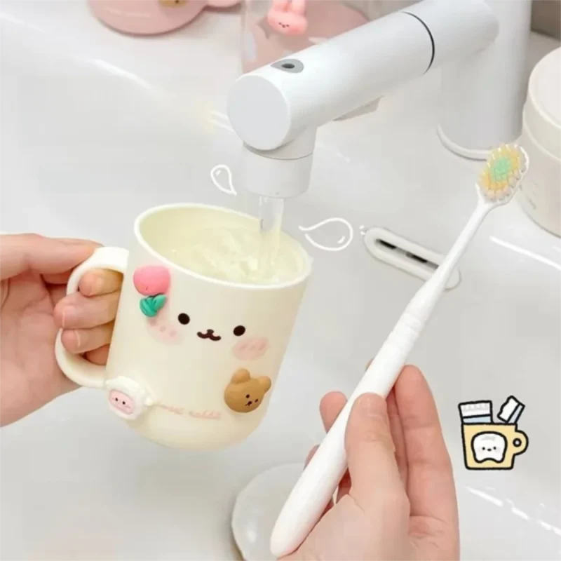 Cream toothbrush cup with animal face print and handle; holds toothbrush and bristles