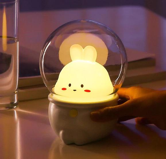 Space bunny night light with glowing clear dome and bunny face on base