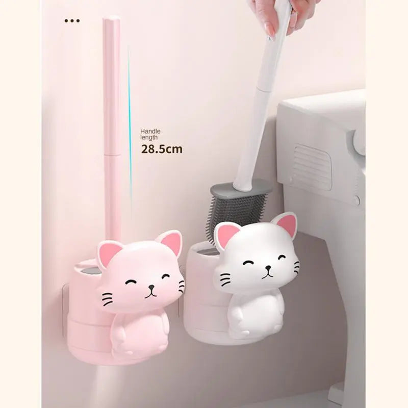 Pink and white cat wall toilet brushes with upright handles and gray bristles.