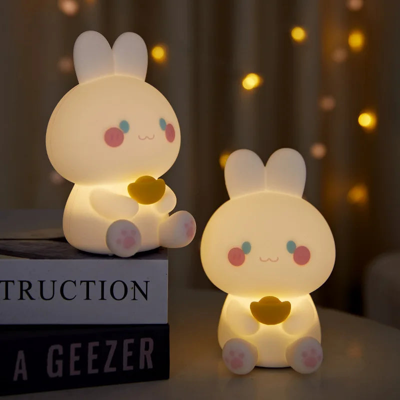 White bunny night light figurines with warm glow and yellow heart, seated