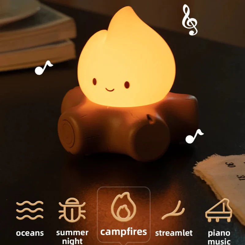 Glowing campfire night light with smiling flame on brown log, front view