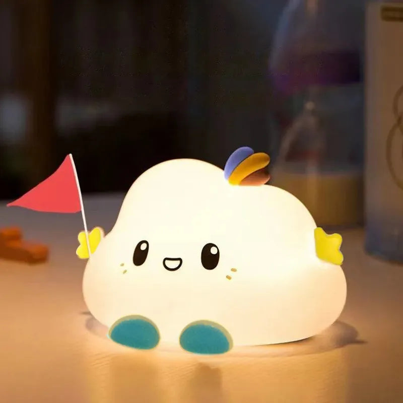 Glowing white cloud LED night light with smiling face, rainbow wing, and blue feet