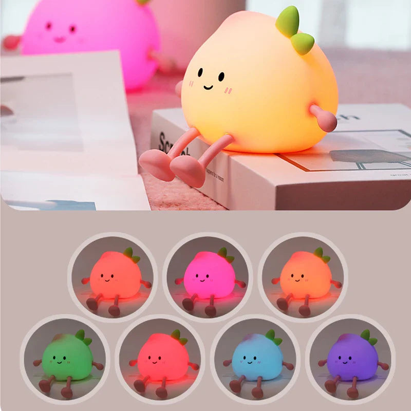 Peach-shaped cute night light with smiling face and green leaf, glowing softly