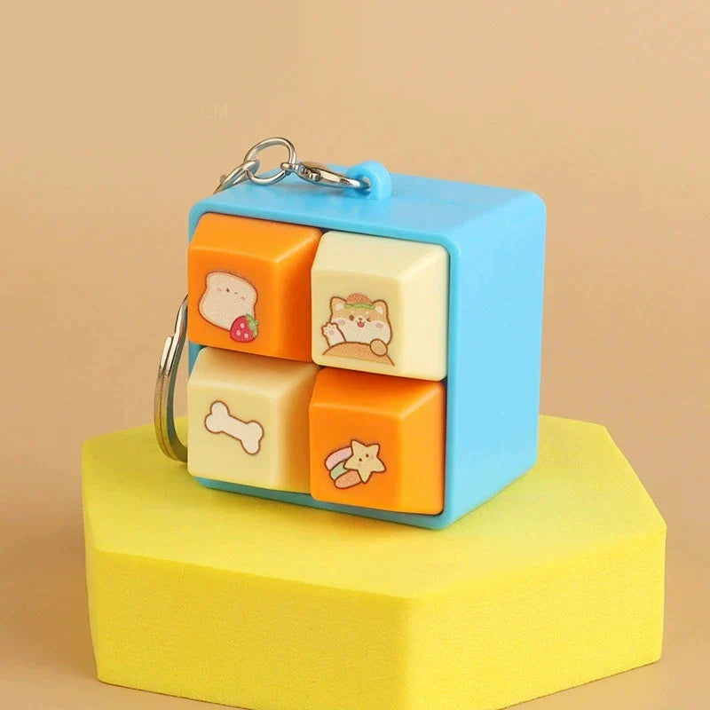 Blue animal fidget clicker keychain cube with bone and star icons.