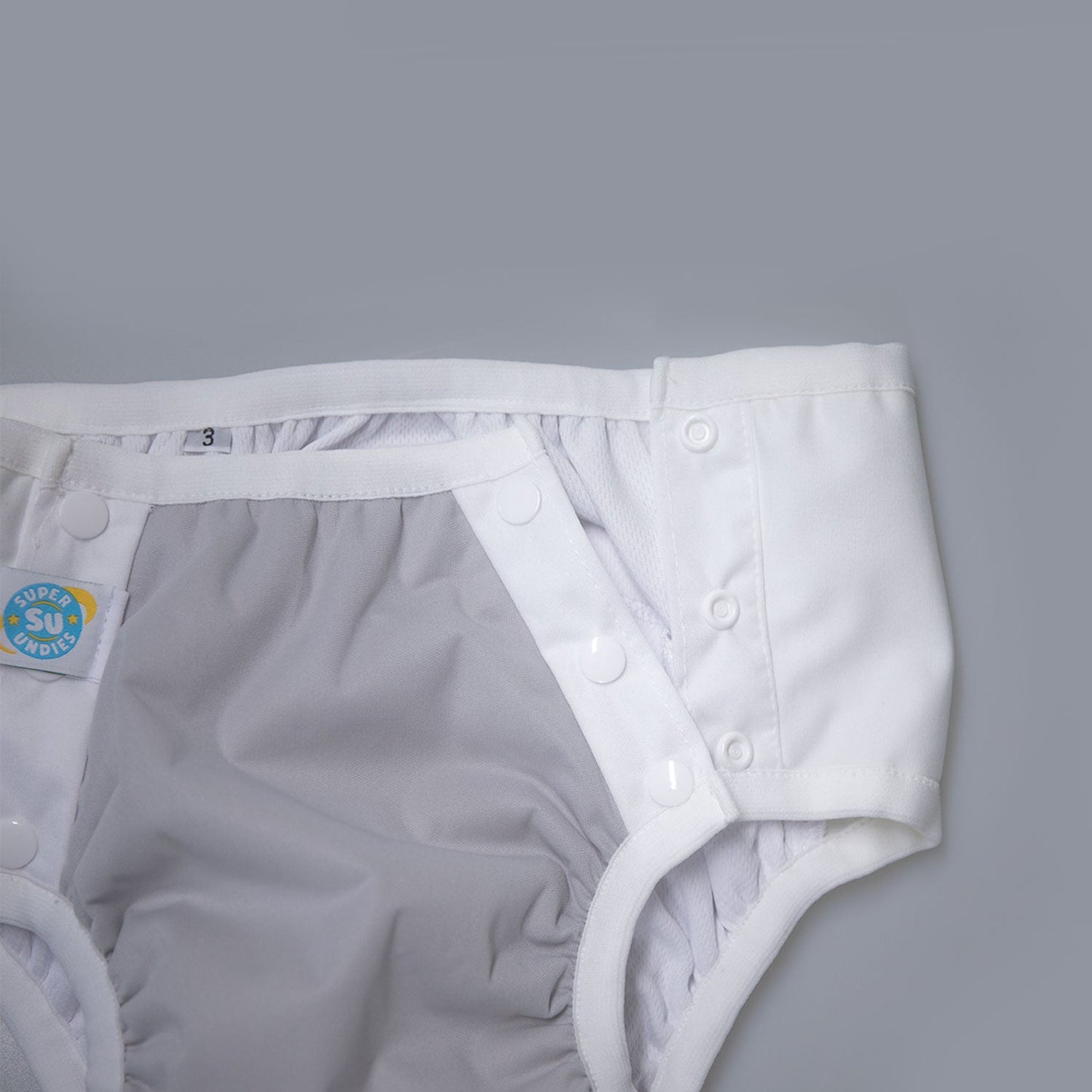 White diaper with button closure on a gray background