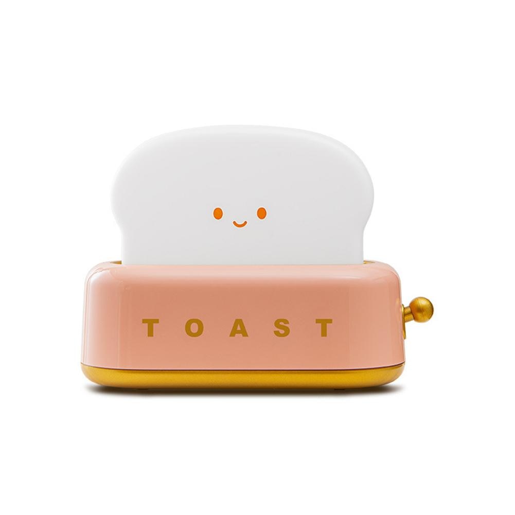 LED toaster night light with pink base and smiling face, golden side knob