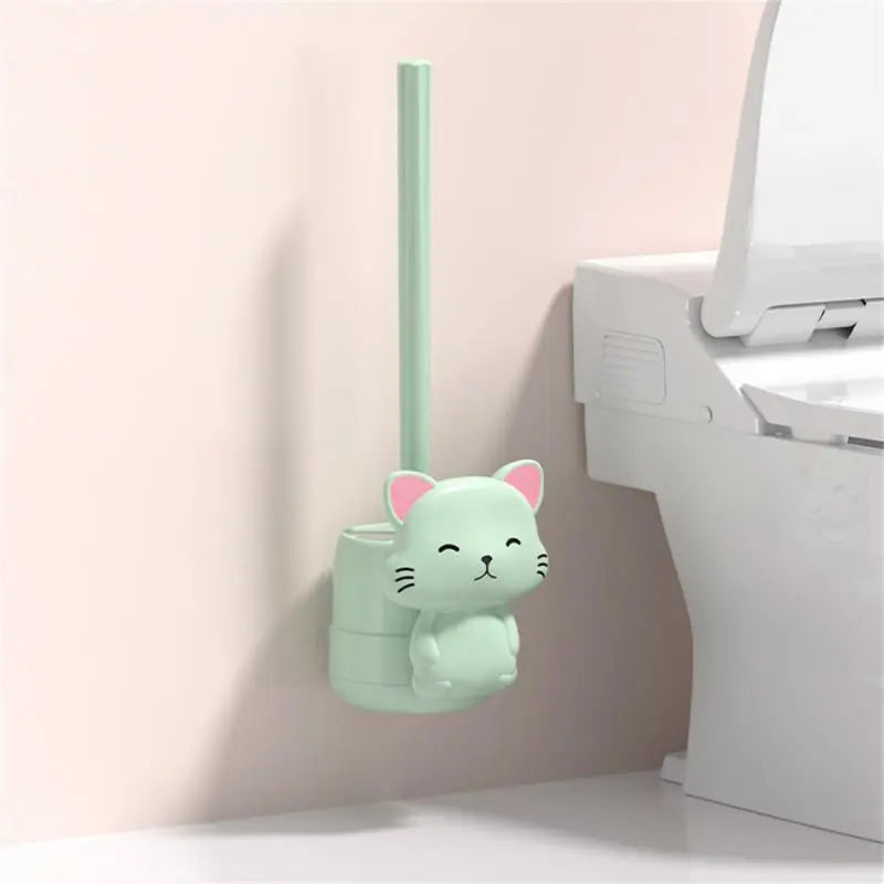 Mint green cat-shaped wall toilet brush with vertical handle and rounded base.