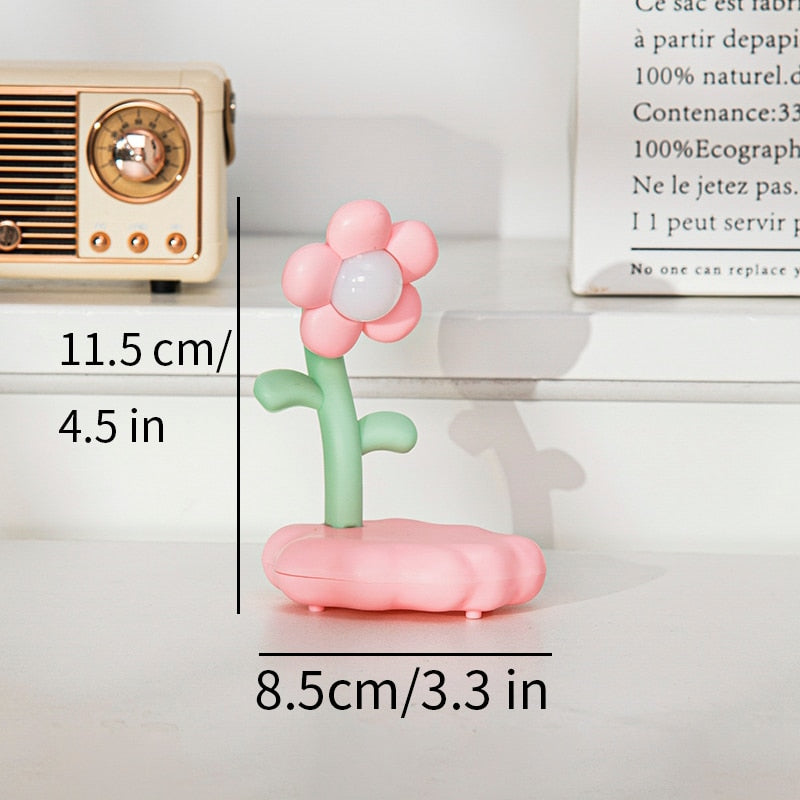 Pink flower night light figurine with glowing base, green stem, and soft flower petals