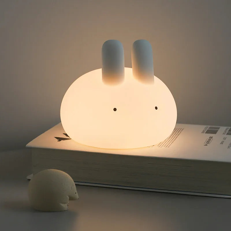 White bunny-shaped rechargeable night light with glowing upright ears