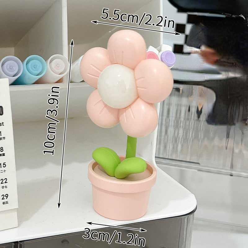 Pink flower night light with glowing center and green leaves in a blush pot