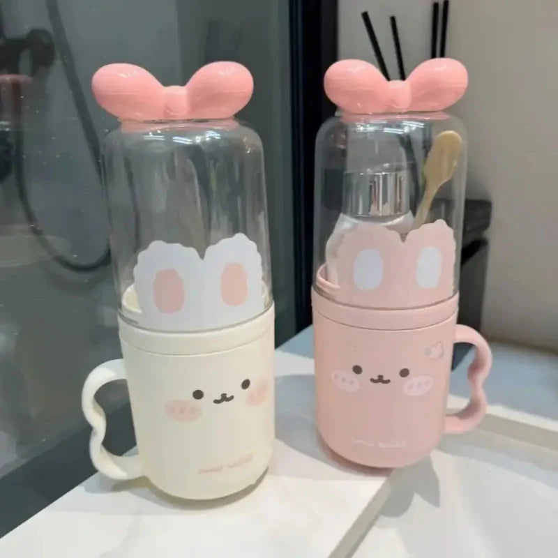 Cute toothbrush holder pair with clear lids and ear-like tops: pink and cream containers