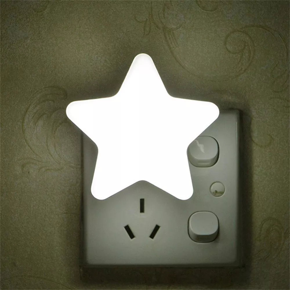 White star LED plug-in night light glowing from a wall outlet.
