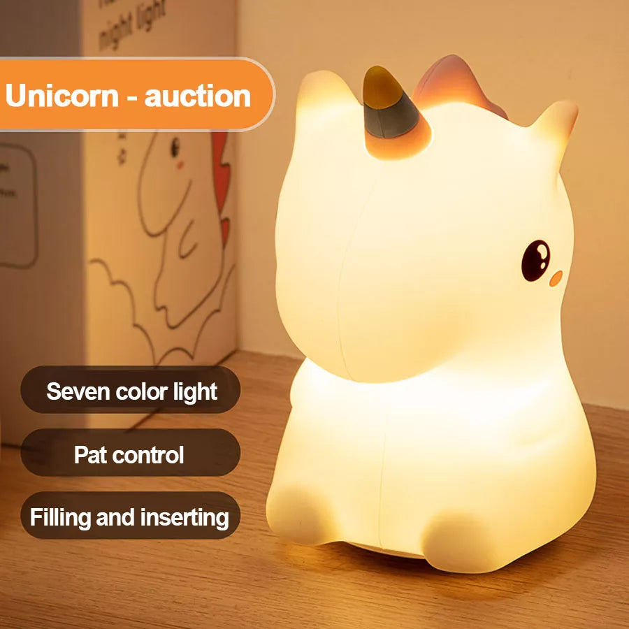 Unicorn LED night light with warm white glow, rounded white body and golden horn