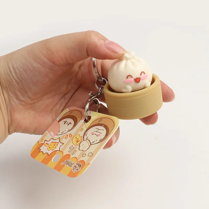 Dumpling fidget clicker keychain: tan mini container with cute face, metal ring and clip