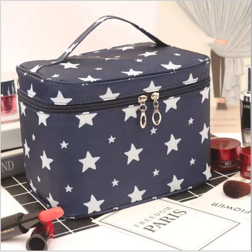 Navy cosmetics toiletry bag with white star pattern, top handle and zip closure