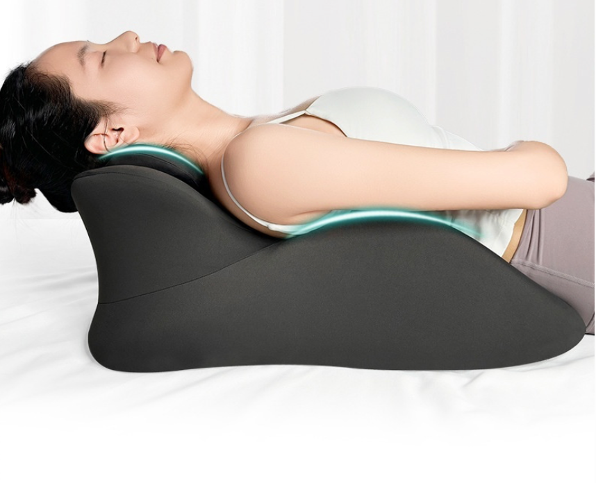 Black body positioning pillow with teal trim for support while lying down