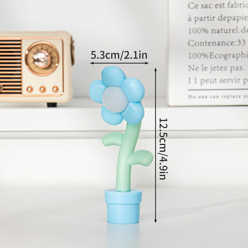 Light blue and white flower night light with green stem and blue pot base
