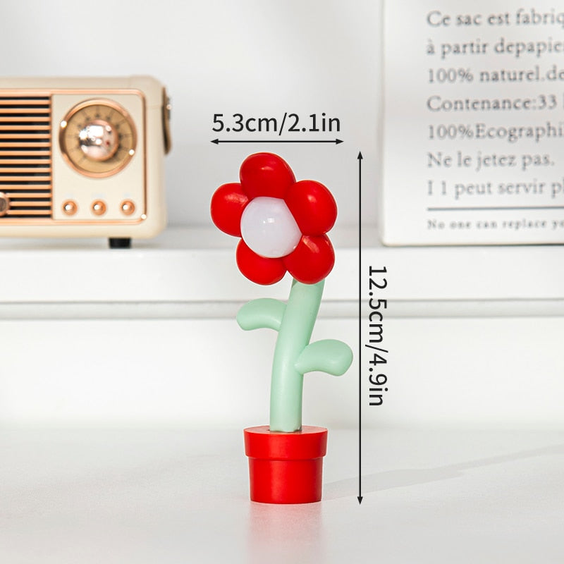 Red and white flower night light with green stem and red pot base