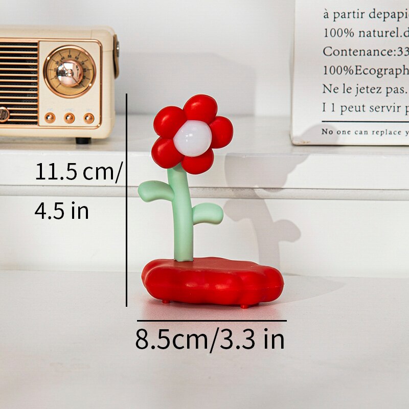 Red and white flower-shaped night light with green stem and base