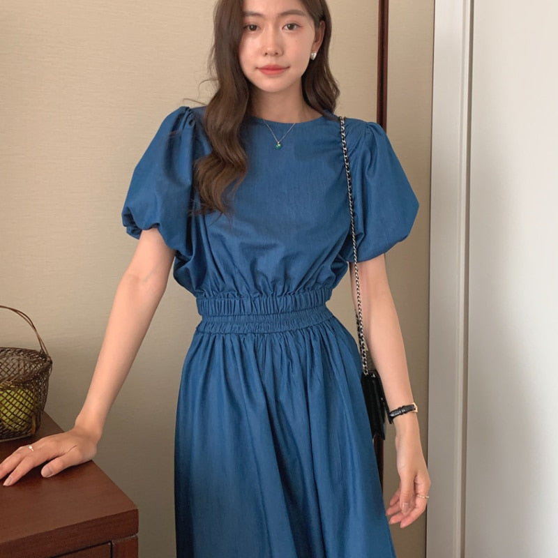 Women’s blue denim puff-sleeve crop top with gathered elastic waist detail