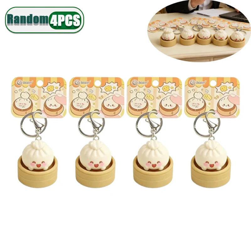 Four dumpling fidget clicker keychains, tan mini containers with cute faces, metal rings