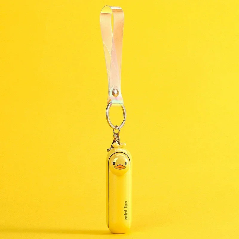 Yellow animal-shaped handheld fan keychain with pale pink ribbon strap