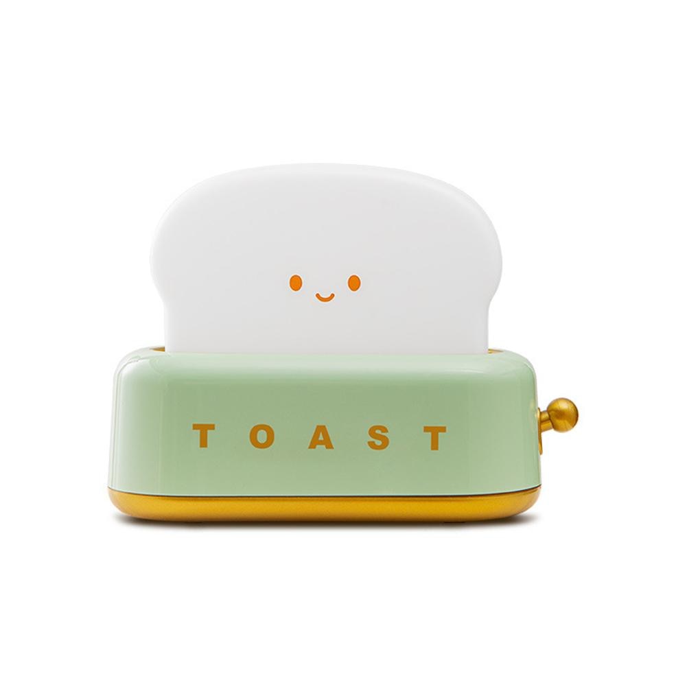 LED toaster night light with green base and smiling face, warm golden side knob