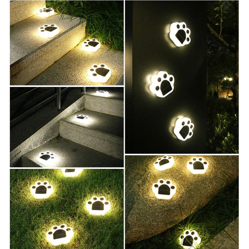 Paw-shaped solar garden lights glowing in multiple spots along a pathway