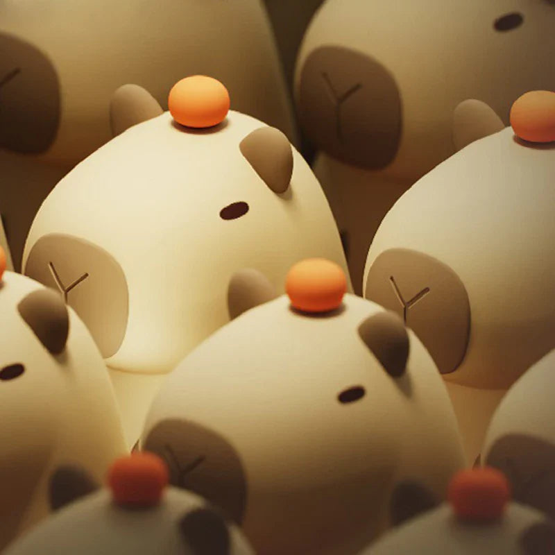 Cluster of capybara night lights with orange knobs, close-up view of faces