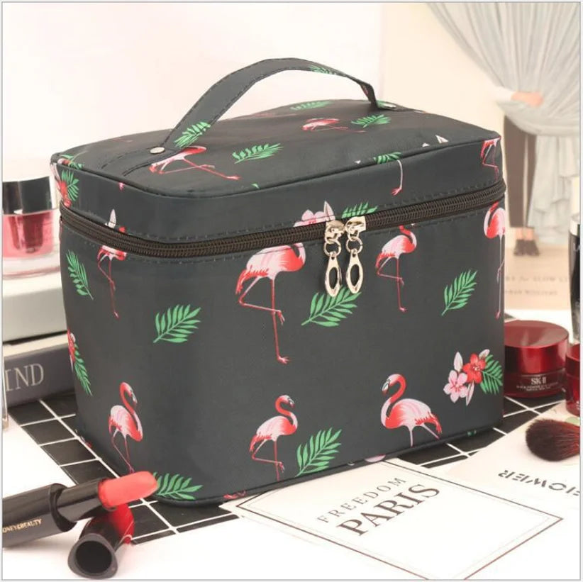 Black cosmetics toiletry bag with flamingo print, top handle and zip closure