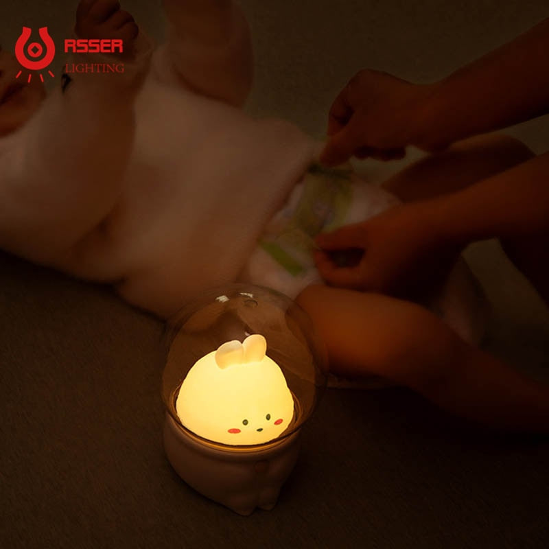 Bunny night light glowing on floor, clear dome with cute bunny face