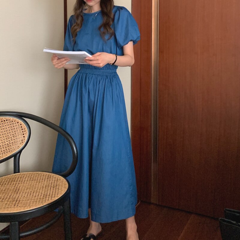 Women’s blue denim puff-sleeve crop top with elastic waist and gathered midi skirt