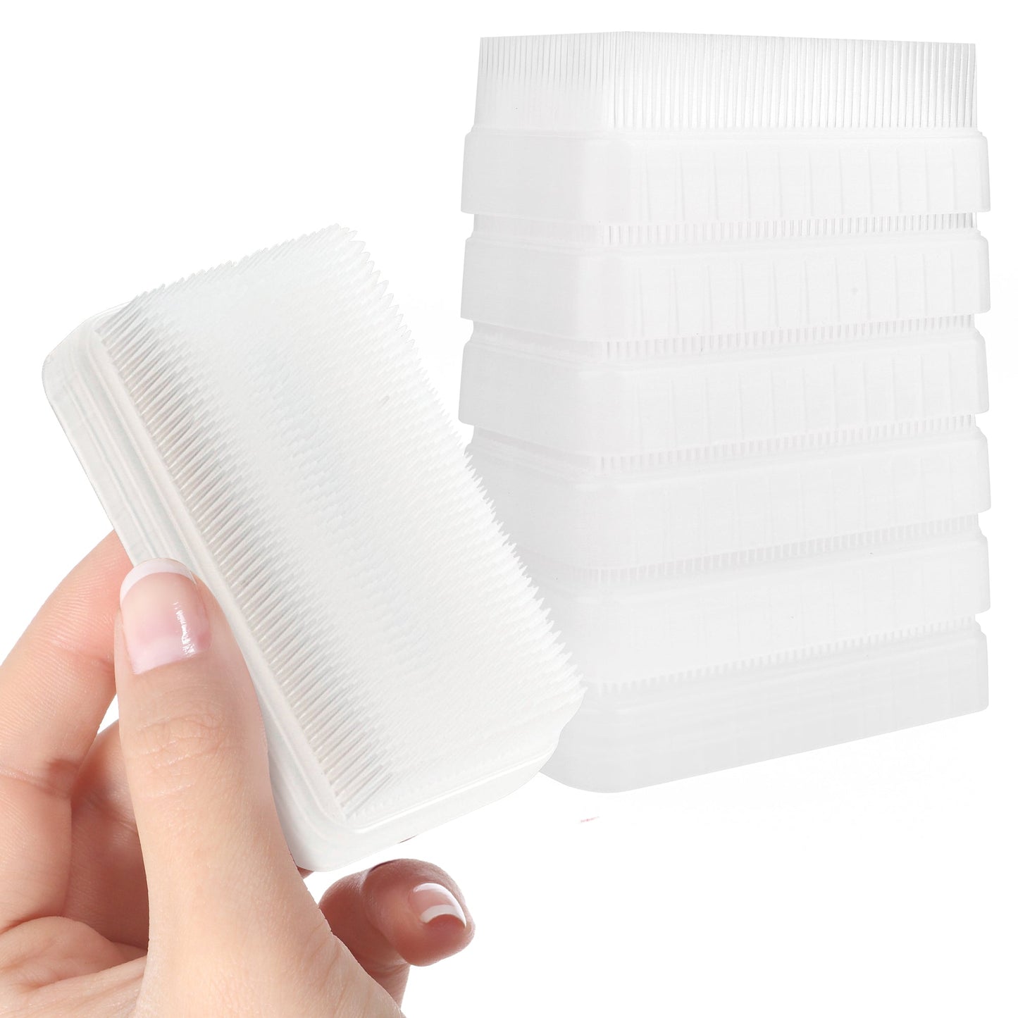 Sensory therapy brush with soft bristles, held beside a stack of cases.